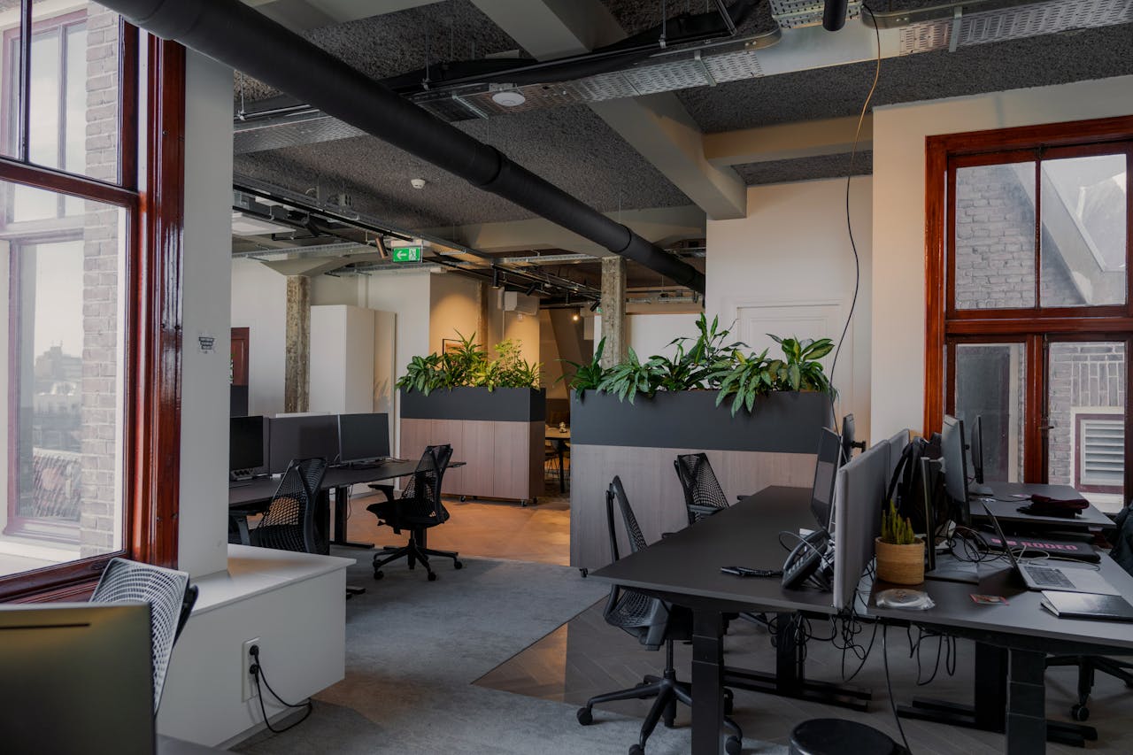 Contemporary office space with desks and plants in Amsterdam.